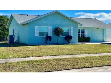 Charming light blue home with well-maintained lawn and landscaping at 6196 Coralberry Ter, Port Charlotte, FL 33981
