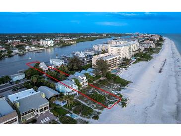 Aerial view of beach house and surrounding area at sunset at 20052 Gulf Blvd, Indian Shores, FL 33785