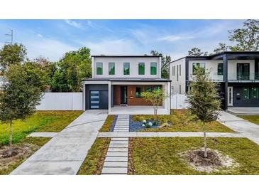 Modern two-story home with a sleek garage, landscaped front yard, and a walkway to the front door at 2721 17Th N Ave, St Petersburg, FL 33713