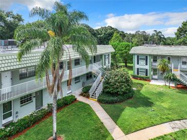 Inviting exterior view of a charming two-story building, surrounded by lush greenery and well-maintained landscaping at 1433 S Belcher Rd # G10, Clearwater, FL 33764