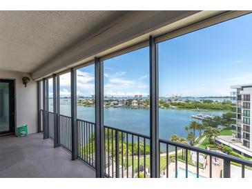 Enjoy the picturesque water view from this condo balcony with black metal railings and neutral flooring at 6 Belleview Blvd # 706, Belleair, FL 33756