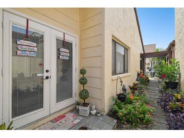 Backyard entry with lush landscaping and a charming walkway at 7518 Clanton Trl, Hudson, FL 34667