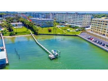 Aerial view of waterfront property with boat dock and building at 100 Bluff View Dr # 208B, Belleair Bluffs, FL 33770