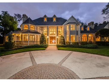 Grand brick house with a circular driveway at dusk at 2901 Leprechaun Ln, Palm Harbor, FL 34683