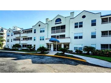 Condo building with attractive exterior and landscaping at 2323 Feather Sound Dr # 202, Clearwater, FL 33762