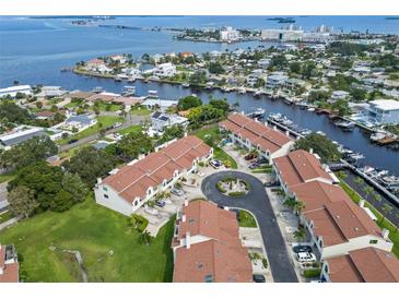 Aerial view of waterfront townhomes with red tile roofs at 2376 Hanover Dr, Dunedin, FL 34698