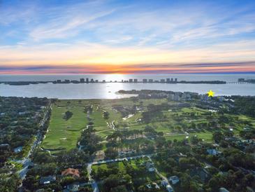 Aerial view showcasing waterfront property near golf course at 100 Oakmont Ln # 301, Belleair, FL 33756