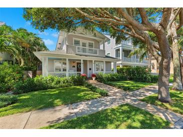 Charming two-story home with a welcoming front porch and beautiful landscaping at 106 19Th Ave, St Pete Beach, FL 33706