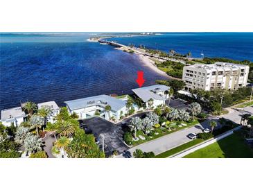 Aerial view showing a waterfront property with a condo building and parking at 2570 Gary Cir # 3, Dunedin, FL 34698