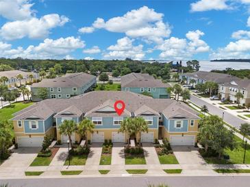 Three-unit townhouse building with light blue exterior at 2505 Arch Ave, Oldsmar, FL 34677