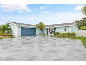 Charming light blue home with a large stone driveway at 5690 Bayview Dr, Seminole, FL 33772