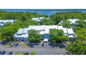Aerial view of community, showcasing building and parking at 2599 Dolly Bay Dr # 308, Palm Harbor, FL 34684