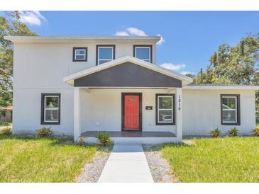 Modern two-story house with a red door and gray siding at 1216 15Th S Ave, St Petersburg, FL 33705