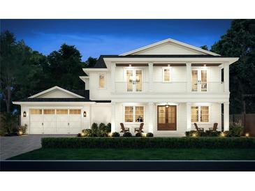 Two-story house with white siding, brown accents, and a two-car garage at 843 Indian Rocks Rd, Belleair, FL 33756