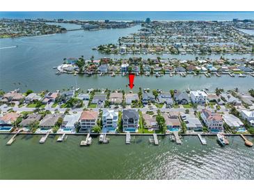 Aerial view showcasing a home's waterfront location in a residential area at 11220 9Th E St, Treasure Island, FL 33706