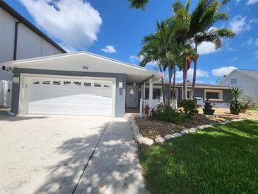 Single-Gathering home with a two-car garage and landscaped yard at 3912 Fontainebleau Dr, Tampa, FL 33634