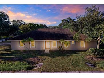 Single story home with a well-maintained lawn and palm trees at 6700 90Th N Ave, Pinellas Park, FL 33782