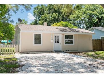 Charming light beige house with white trim and a spacious driveway at 4000 7Th N Ave, St Petersburg, FL 33713
