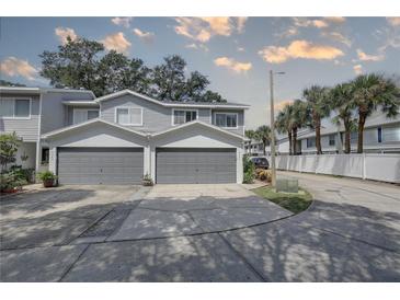 Two-car attached garage with gray doors at 9247 Jakes Path, Largo, FL 33771