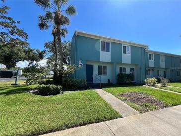 Front view of two-story teal condo with landscaping at 182 114Th Ne Ter # 182, St Petersburg, FL 33716