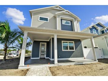 Two-story Craftsman style home with front porch and landscaping at 3839 71St N St, St Petersburg, FL 33709