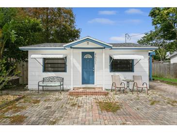 White cottage with blue door and brick patio at 4631 42Nd N Ave, St Petersburg, FL 33714