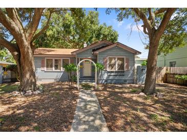 Quaint light blue house with a walkway and mature trees at 1727 22Nd N Ave, St Petersburg, FL 33713