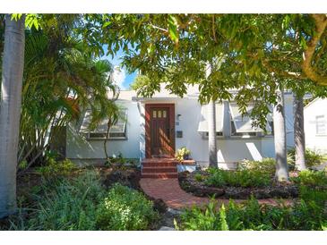 Charming bungalow with lush landscaping and brick pathway at 2827 11Th N Ave, St Petersburg, FL 33713
