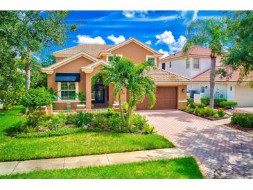 Charming home boasts lush landscaping, a paved driveway, and a well-maintained lawn, enhancing its curb appeal at 9883 Sago Point Dr, Seminole, FL 33777