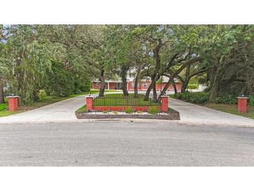 Two-story home with brick facade and circular driveway at 8417 Cranes Roost Dr, New Port Richey, FL 34654