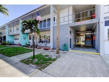 Charming condo building with neat landscaping, sidewalk and an American flag waving at 5820 43Rd N Ter # 1406, St Petersburg, FL 33709