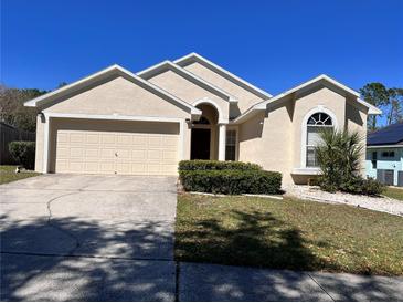 Charming single-Gathering home with a two-car garage and well-maintained front yard at 418 Henderson Ave, Seffner, FL 33584
