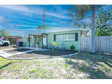 Charming single-story home with a well-manicured lawn and an American flag at 7226 13Th N St, St Petersburg, FL 33702