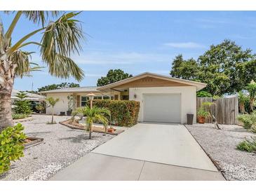 Charming single-story home with manicured landscaping, a driveway, and a welcoming entrance at 6012 1St W Ave, Bradenton, FL 34209