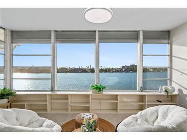 Relaxing water view from an open living space, featuring comfortable seating and natural light at 770 Island Way # N302, Clearwater, FL 33767