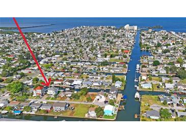 A captivating aerial view showcases the waterfront property with boat docks, nestled in a vibrant coastal community at 13753 Judy Ave, Hudson, FL 34667