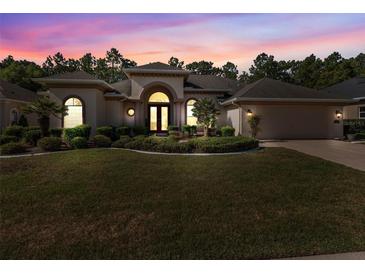 Attractive single-story home with landscaping and two-car garage at 5378 Legend Hills Ln, Spring Hill, FL 34609