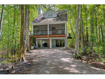 Two-story waterfront home with a large deck at 7413 Gettysburg Dr, Weeki Wachee, FL 34607