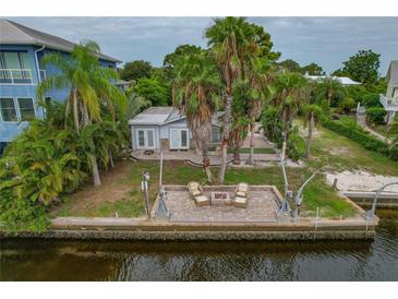 Backyard oasis with patio, firepit and canal-front access at 9 Grace St, Crystal Beach, FL 34681