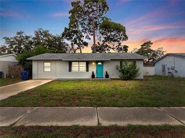 Charming single story house with teal door at 3124 Lecanto St, Holiday, FL 34691