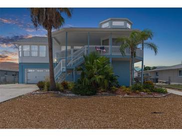 Charming waterfront home with a two-story design and stunning sunset views at 13521 Stacey Dr, Hudson, FL 34667