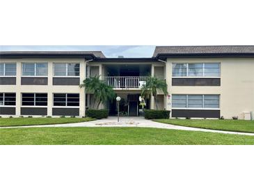Condo building exterior with entrance and landscaping at 5123 Topaz Ln # 105, New Port Richey, FL 34652