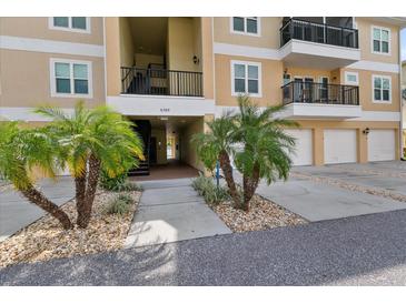 Inviting condo exterior featuring well-manicured landscaping and convenient garage parking at 6395 Banyan Blvd # 204, New Port Richey, FL 34652