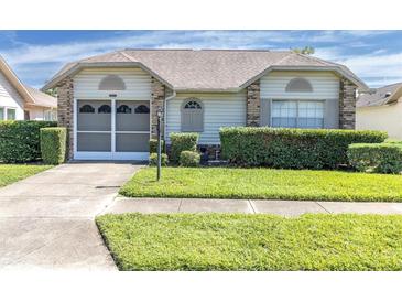 One-story house with a two-car garage and neatly landscaped yard at 4750 Carrington Ct, New Port Richey, FL 34655