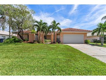 Single-Gathering home with a large lawn and attached garage at 2044 Montana Ne Ave, St Petersburg, FL 33703
