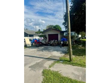House exterior with garage and multiple vehicles parked on the property at 3310 68Th N Ave, St Petersburg, FL 33702