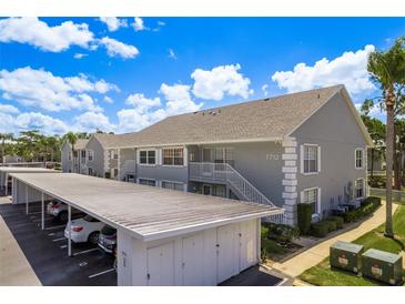 Charming condo featuring a two-story building with carport parking in a well-maintained community at 7712 Hillside Ct # 202, Hudson, FL 34667