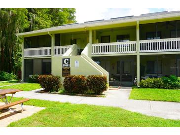 Exterior view of a two-story building with a staircase and landscaping at 20861 Haulover Cv # C4, Lutz, FL 33558