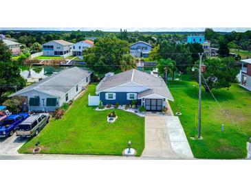 Charming home with manicured lawn, water feature, and water access, creating a serene and inviting outdoor space at 3178 Sea Grape Dr, Hernando Beach, FL 34607