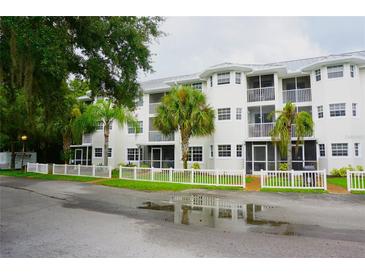 Two-story condo building with white exterior and balconies at 2077 Wetland Pt # 1103, Lutz, FL 33558